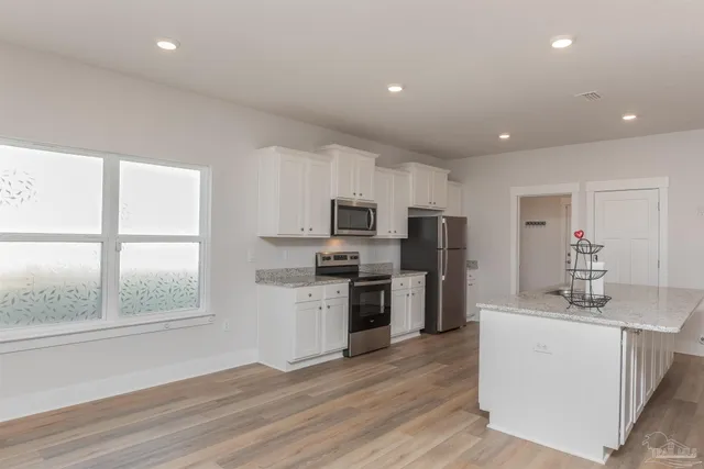 a kitchen with refrigerator a sink and a stove top oven