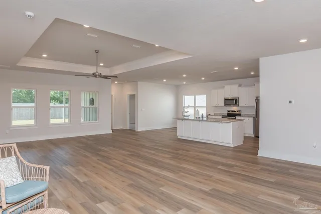 a view of kitchen with refrigerator and window