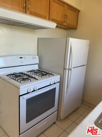 a stove top oven sitting inside of a kitchen