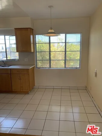 a kitchen with a sink a counter top space and cabinets