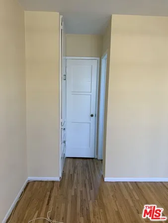 a view of hallway with wooden floor