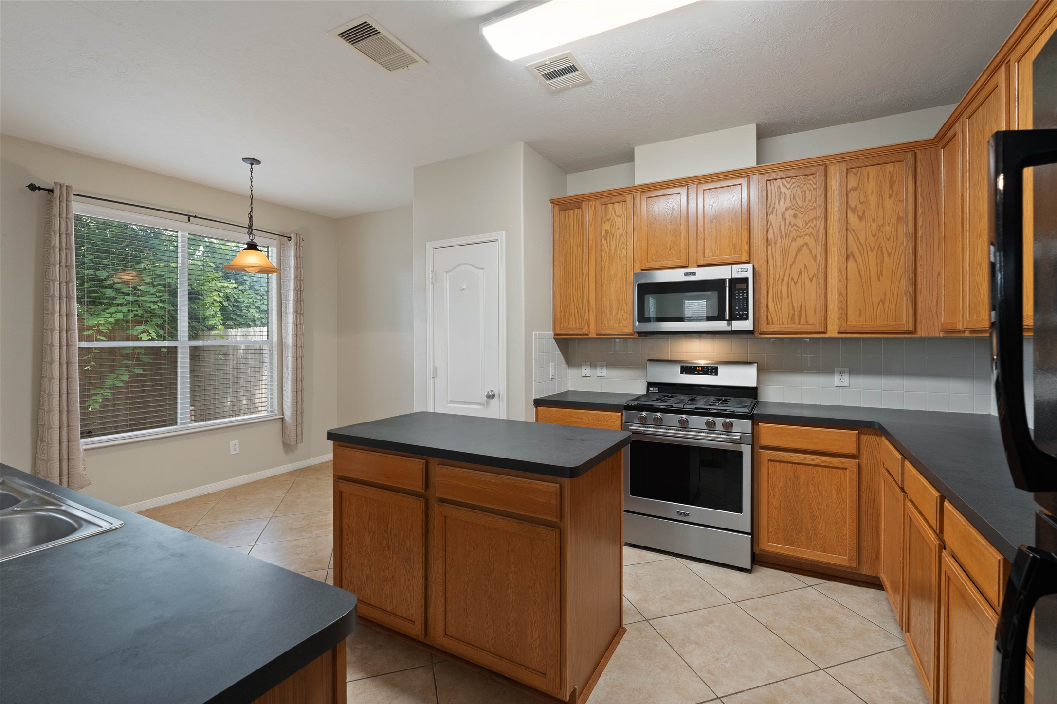 7414 Hollister Spring Houston, TX 77040 - Photo 11 of 26 Island kitchen with stainless steel appliances & opens to breakfast area.