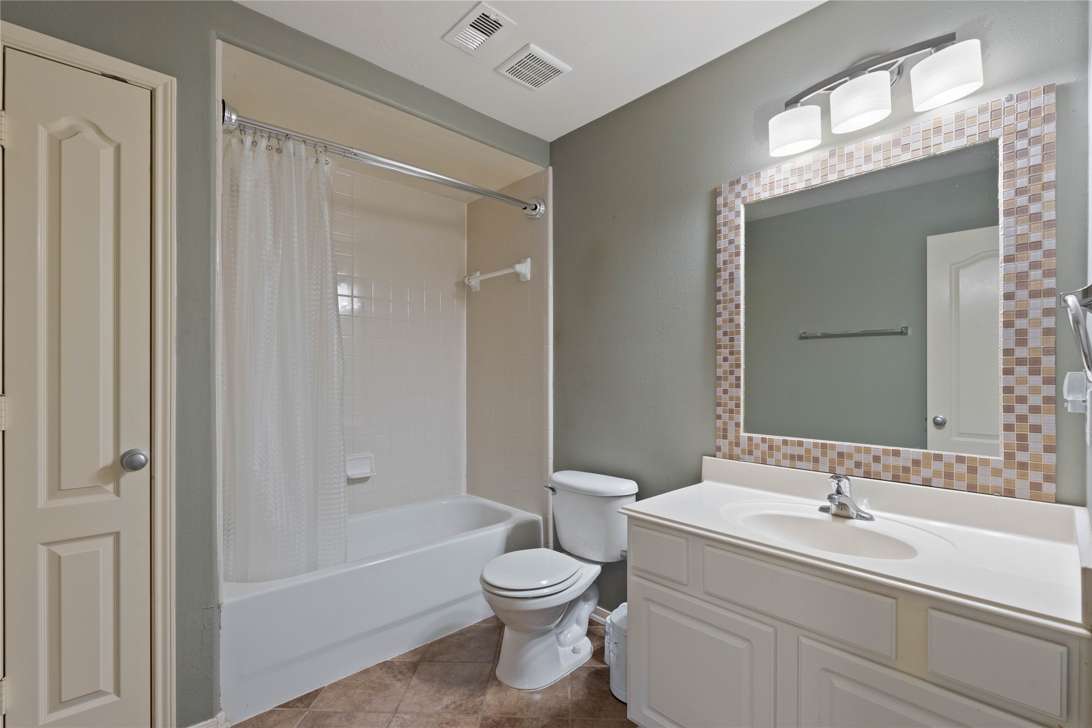 7414 Hollister Spring Houston, TX 77040 - Photo 21 of 26 Charming secondary bathroom with modern lighting, stylish vanity, and a clean, inviting design.
