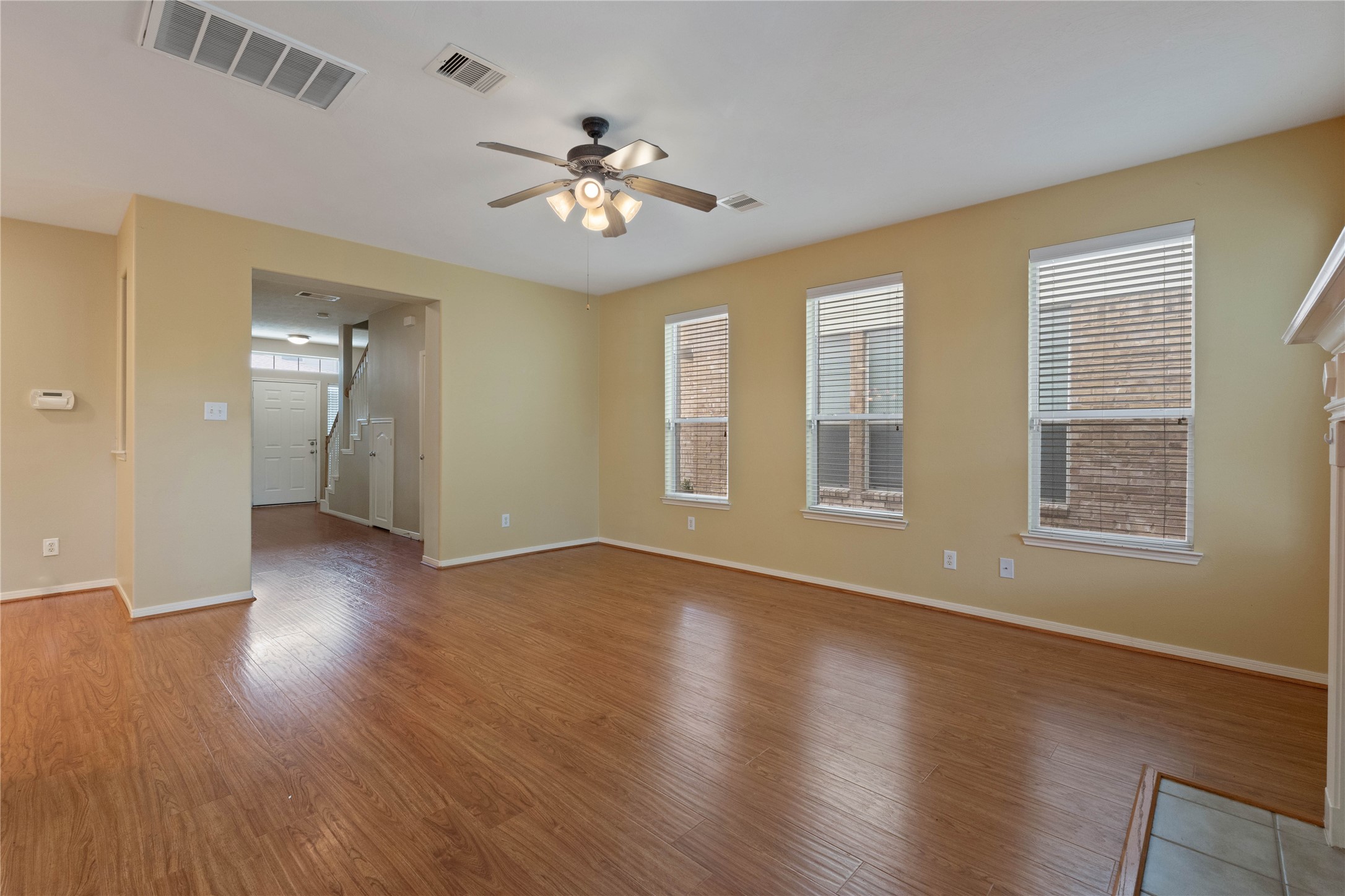 7414 Hollister Spring Houston, TX 77040 - Photo 6 of 26 Bright and airy living room featuring neutral tones, a ceiling fan, and an inviting open layout.