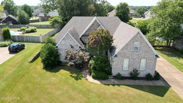 a view of a house with a yard and sitting area