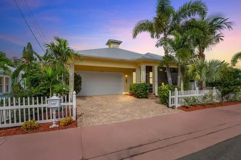 a view of a house with palm trees