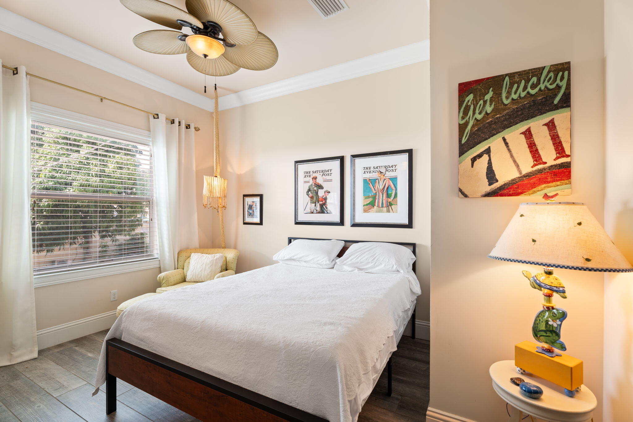 412 Southwest Akron Avenue Stuart, FL 34994 - Photo 27 of 60 a bedroom with a bed and a painting on the wall