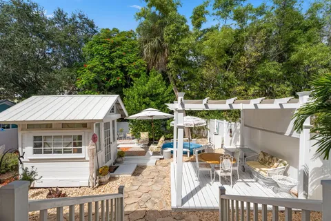 a view of backyard of house with seating space