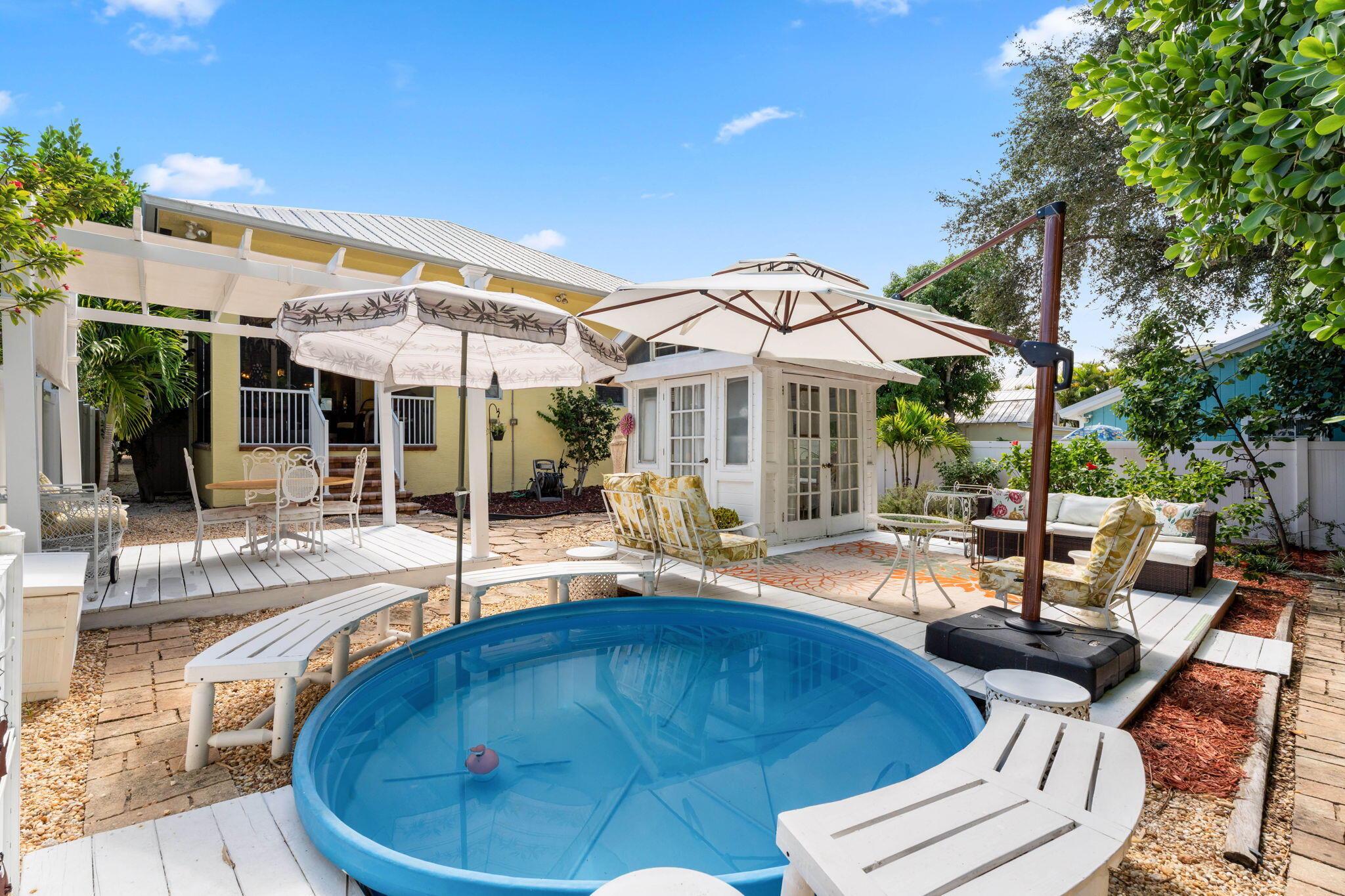 412 Southwest Akron Avenue Stuart, FL 34994 - Photo 45 of 60 a view of a patio with swimming pool table and chairs