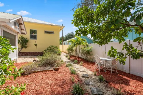 a front view of a house with a yard and fountain in middle