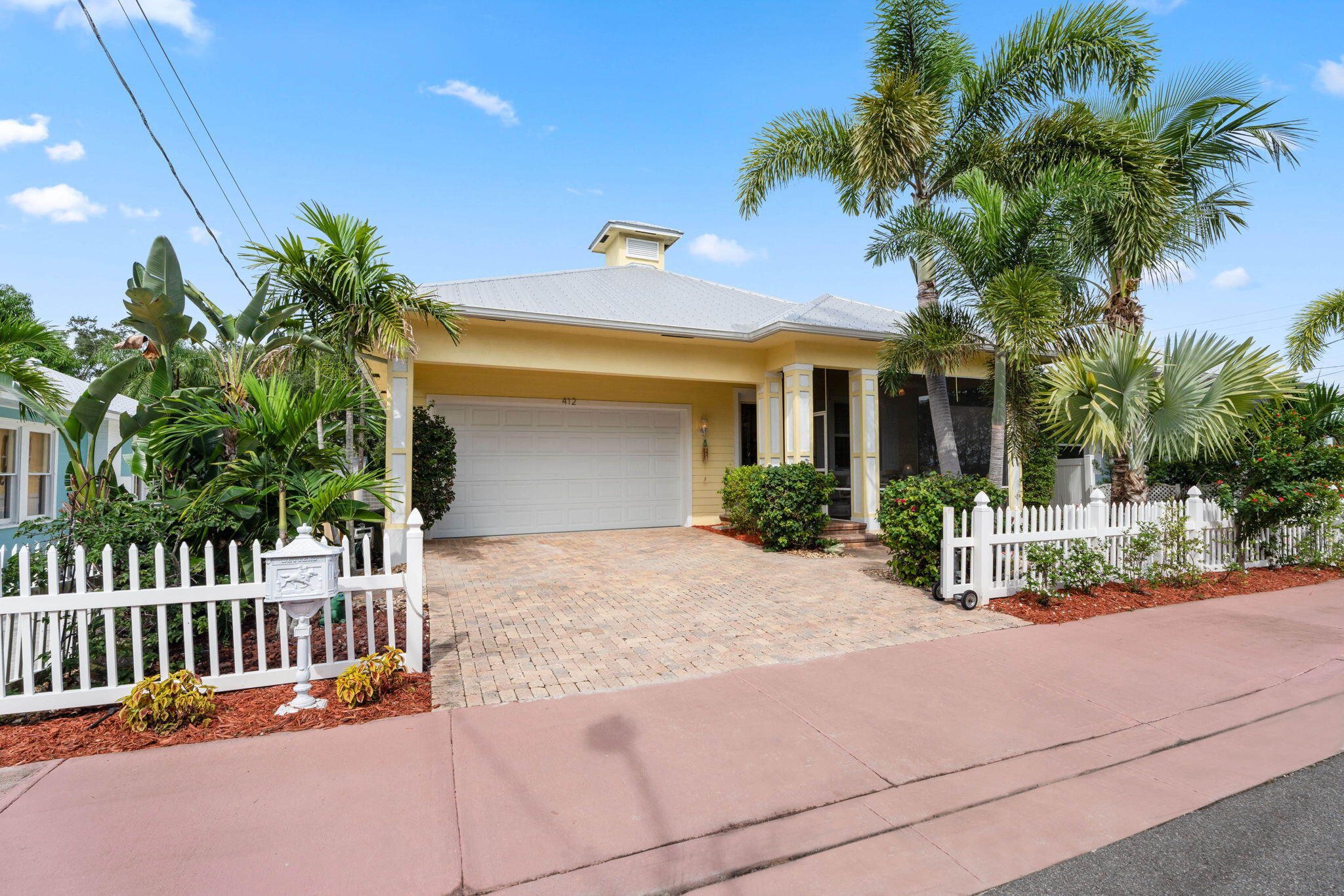 412 Southwest Akron Avenue Stuart, FL 34994 - Photo 6 of 60 a view of a house with a small yard and potted plants