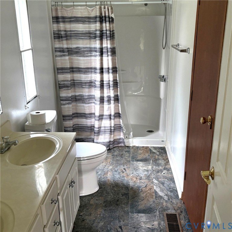 102 Frenchs Store Road Cumberland, VA 23040 - Photo 11 of 13 Bathroom featuring a white vanity, and a stand-up