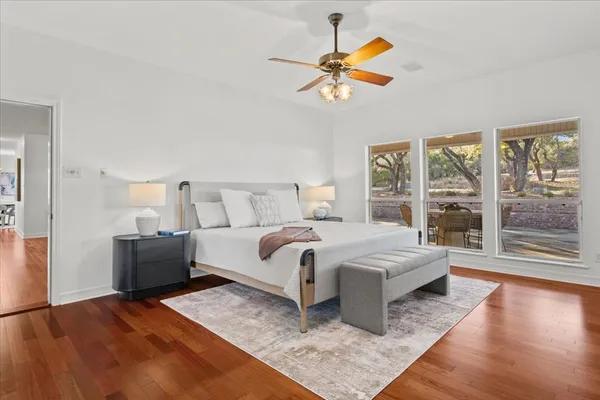 a bedroom with a large bed and a large window
