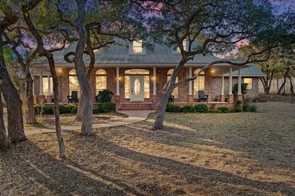 a view of a house with a tree in front