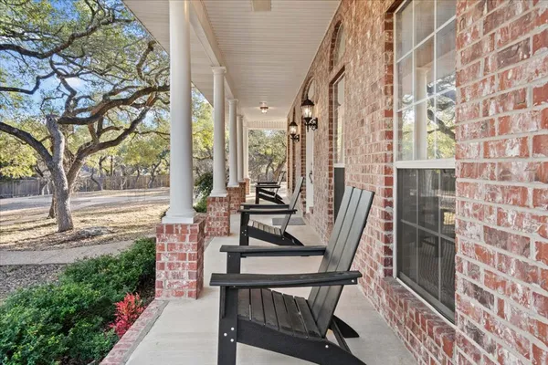 a view of a balcony with chairs and a table