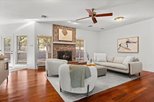 a living room with furniture a fireplace and a flat screen tv