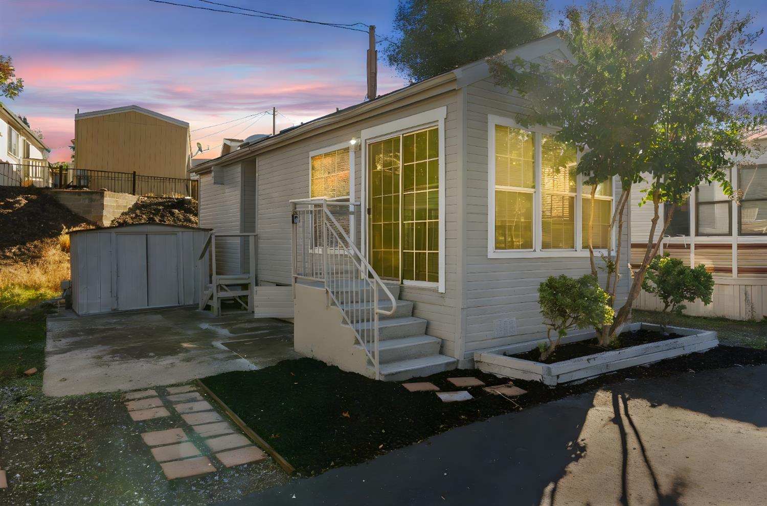 a view of a house with backyard sitting area and garden