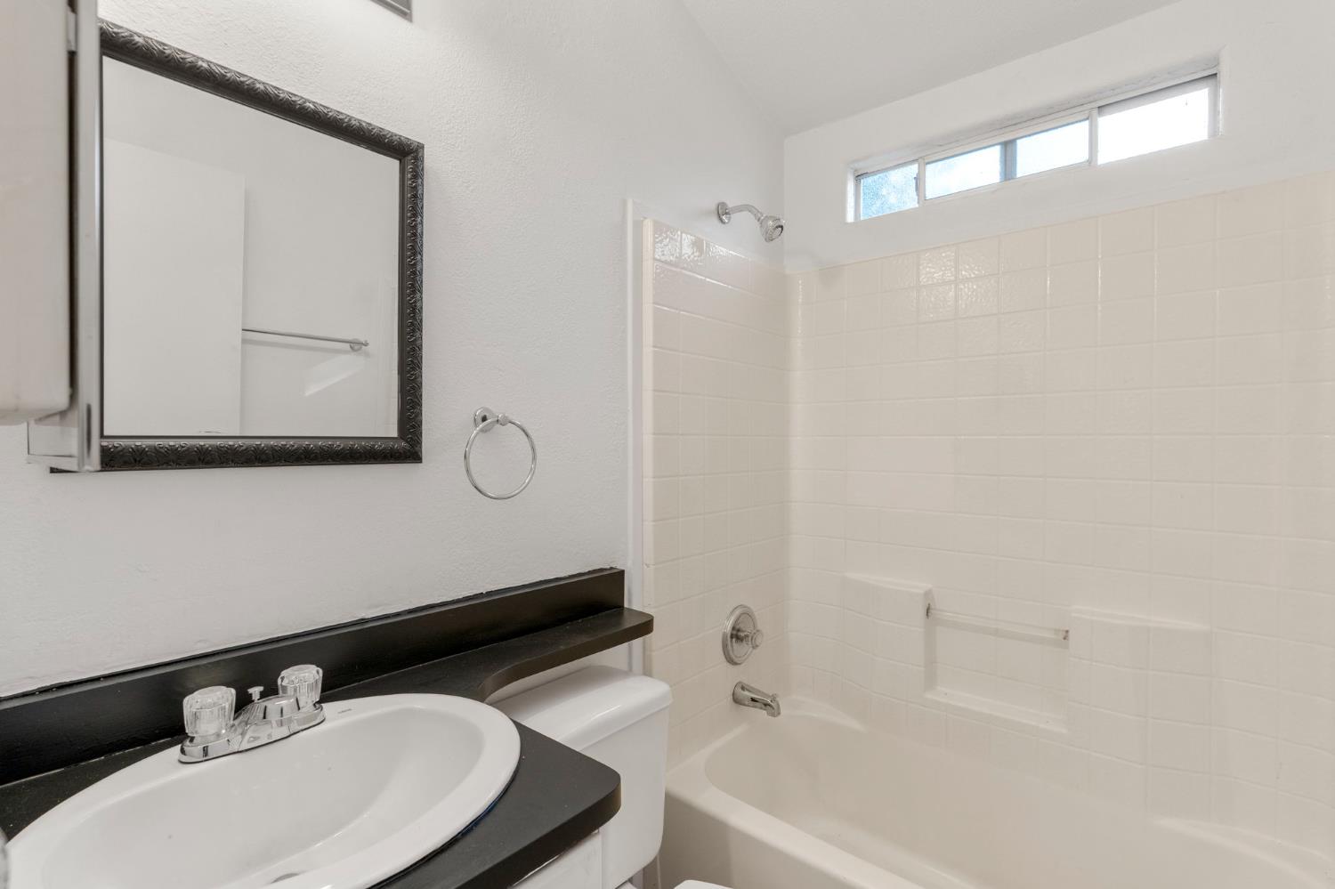 607 Mountain Ranch Road, Unit 5 San Andreas, CA 95249 - Photo 13 of 16 a bathroom with a sink vanity tub and a mirror