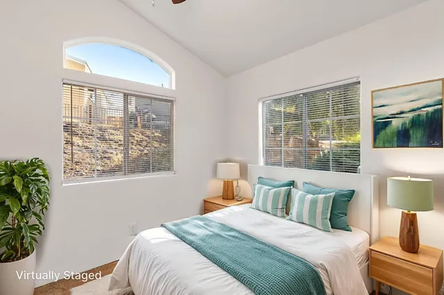 a bedroom with bed and a window