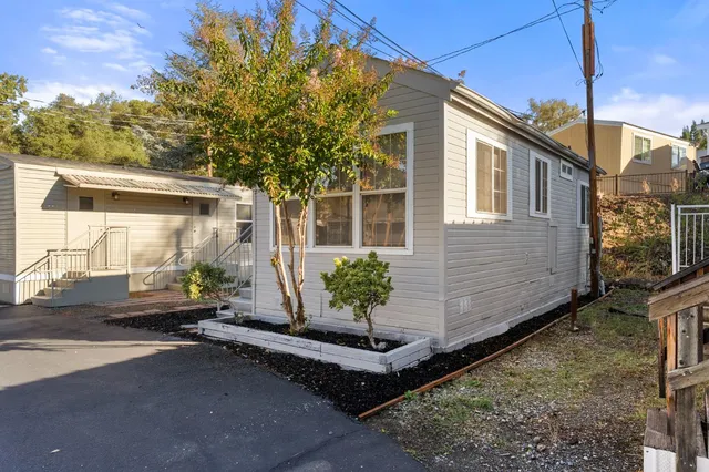 a view of a house with backyard and sitting area