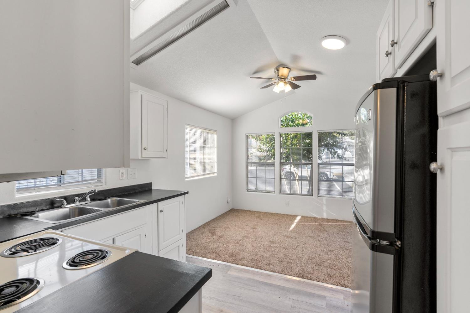 607 Mountain Ranch Road, Unit 5 San Andreas, CA 95249 - Photo 5 of 16 a view of a kitchen with a stove wooden floor and a window