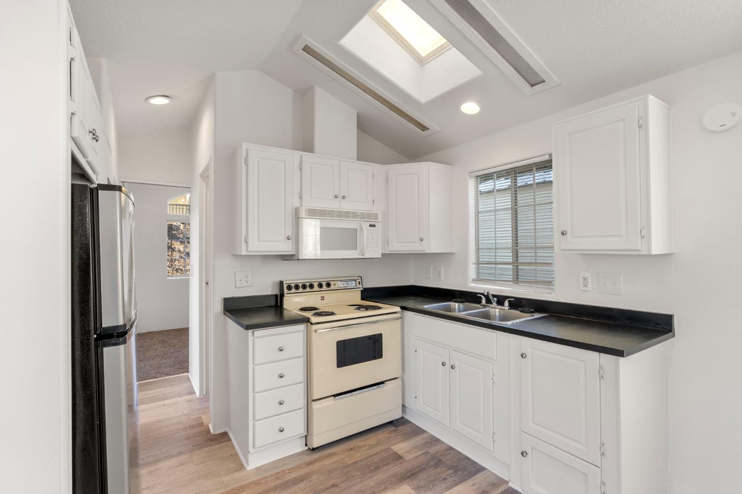 607 Mountain Ranch Road, Unit 5 San Andreas, CA 95249 - Photo 7 of 16 a kitchen with stainless steel appliances granite countertop a sink stove and refrigerator
