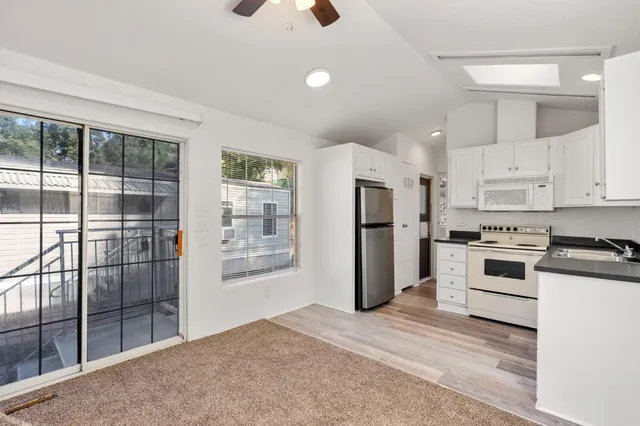 a kitchen with a refrigerator a stove top oven and white kitchen island