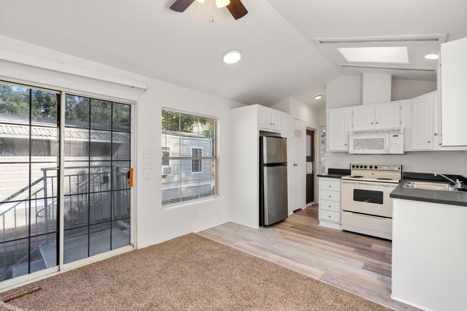 607 Mountain Ranch Road, Unit 5 San Andreas, CA 95249 - Photo 10 of 16 a kitchen with a refrigerator a stove top oven and white kitchen island