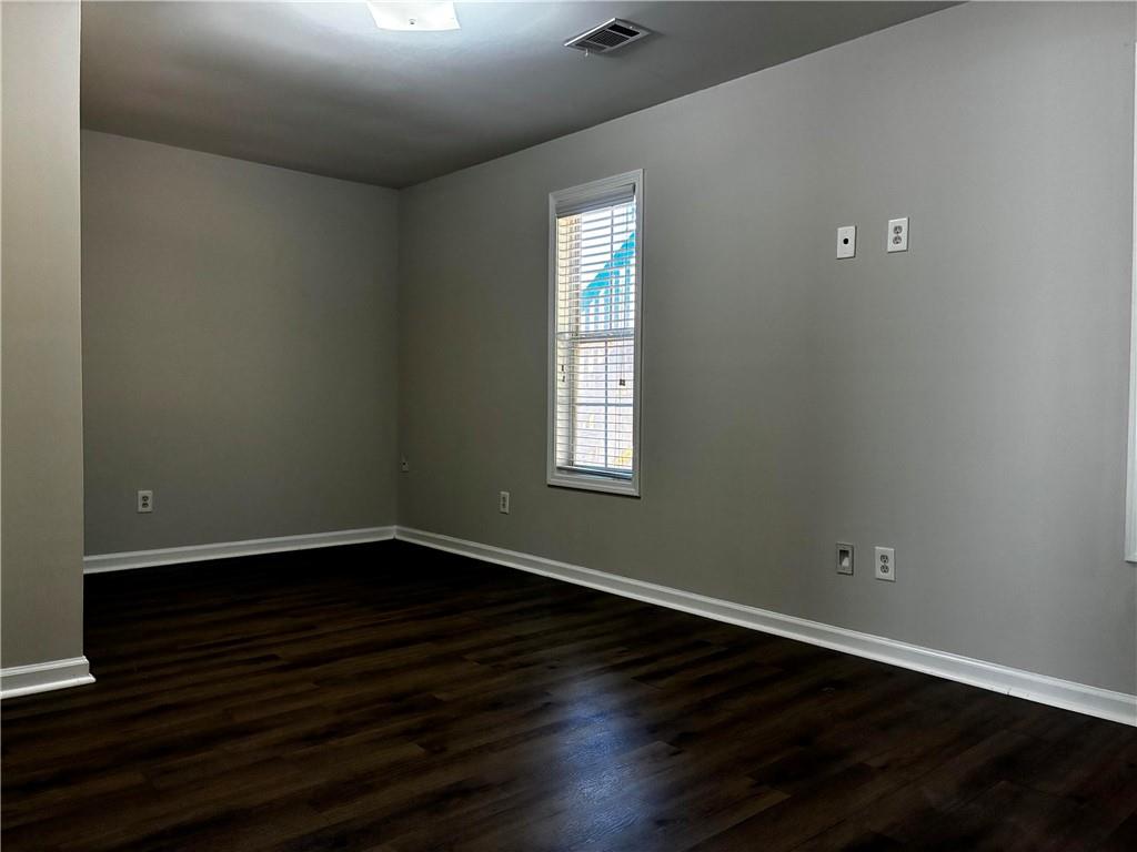 337 Madison Avenue Hampton, GA 30228 - Photo 27 of 32 a view of an empty room with wooden floor and a window