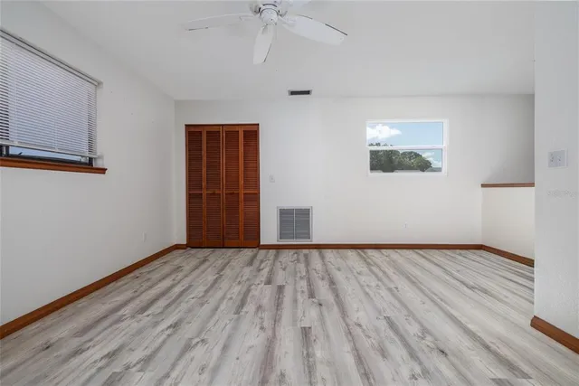 a view of an empty room with wooden floor