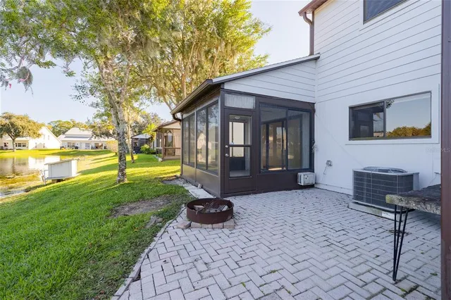 a view of a house with backyard and sitting area