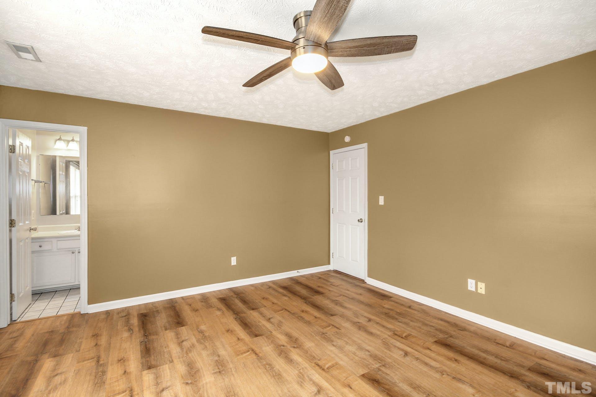 813 Rim Road Fayetteville, NC 28314 - Photo 13 of 25 a view of a big room with wooden floor and a ceiling fan