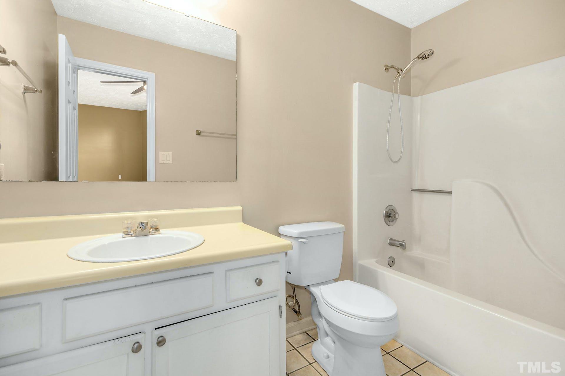 813 Rim Road Fayetteville, NC 28314 - Photo 14 of 25 a bathroom with a sink toilet and shower
