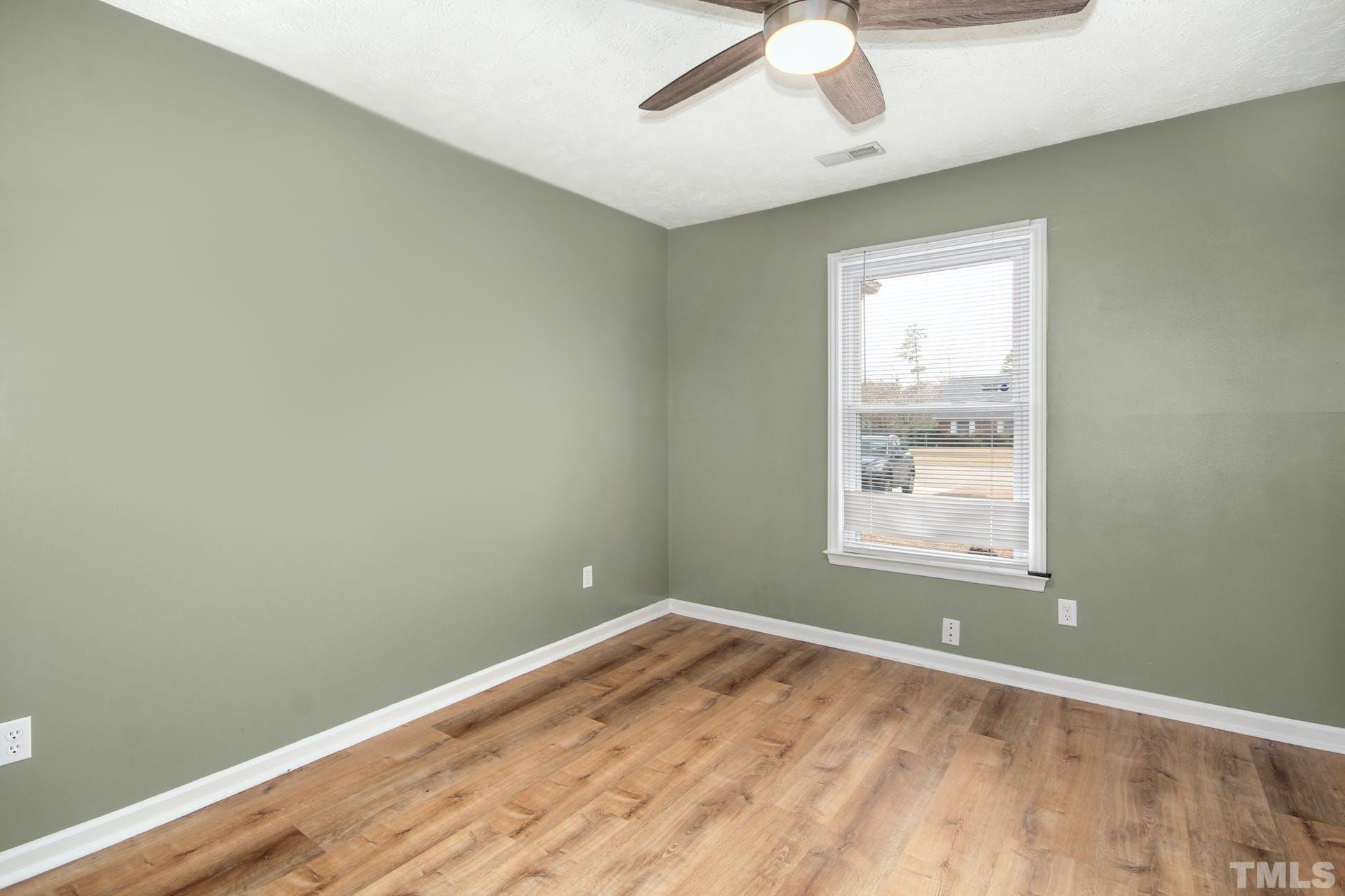 813 Rim Road Fayetteville, NC 28314 - Photo 16 of 25 an empty room with a window and wooden floor