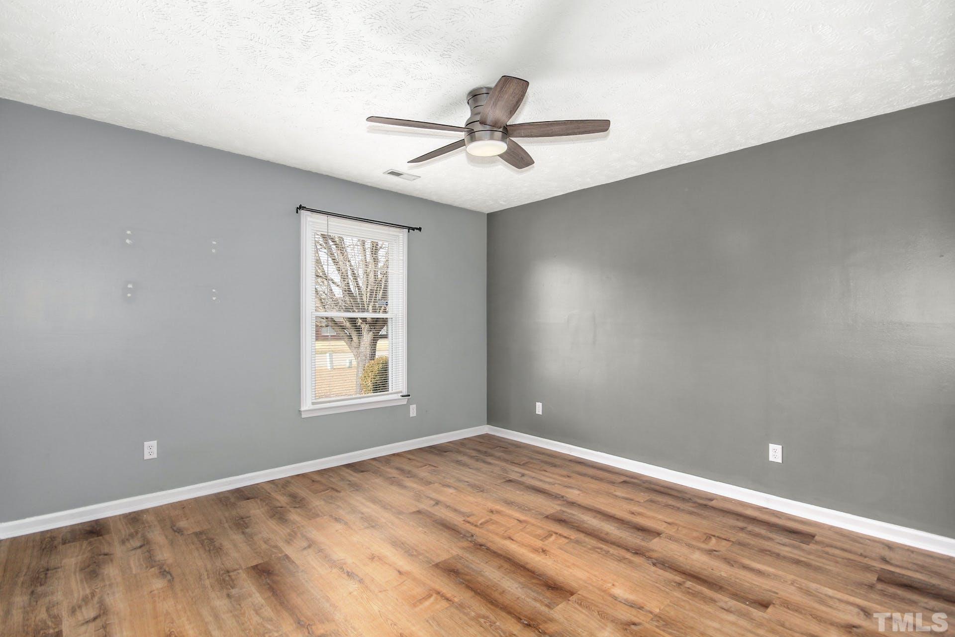 813 Rim Road Fayetteville, NC 28314 - Photo 17 of 25 an empty room with windows and ceiling fan
