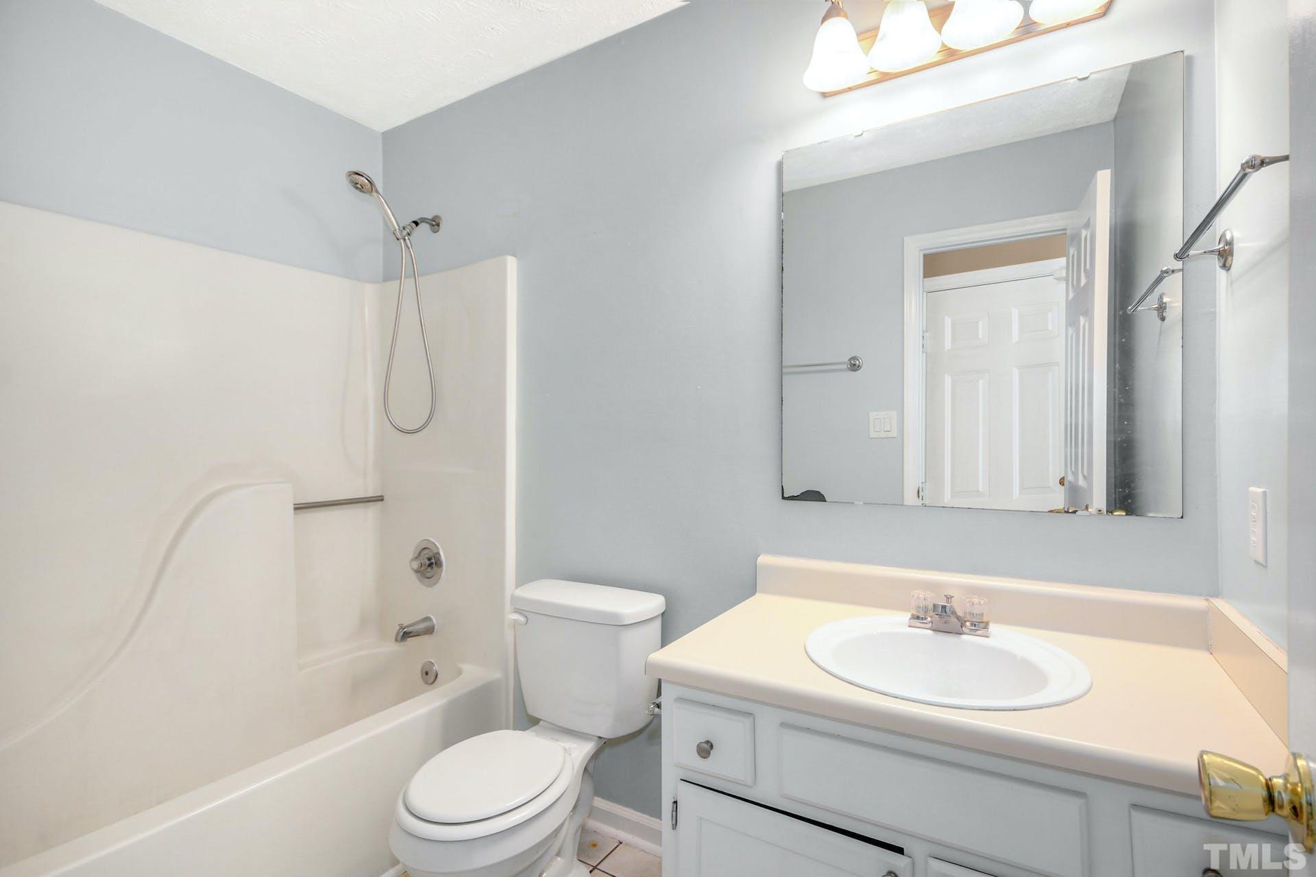 813 Rim Road Fayetteville, NC 28314 - Photo 18 of 25 a bathroom with a sink toilet vanity and shower