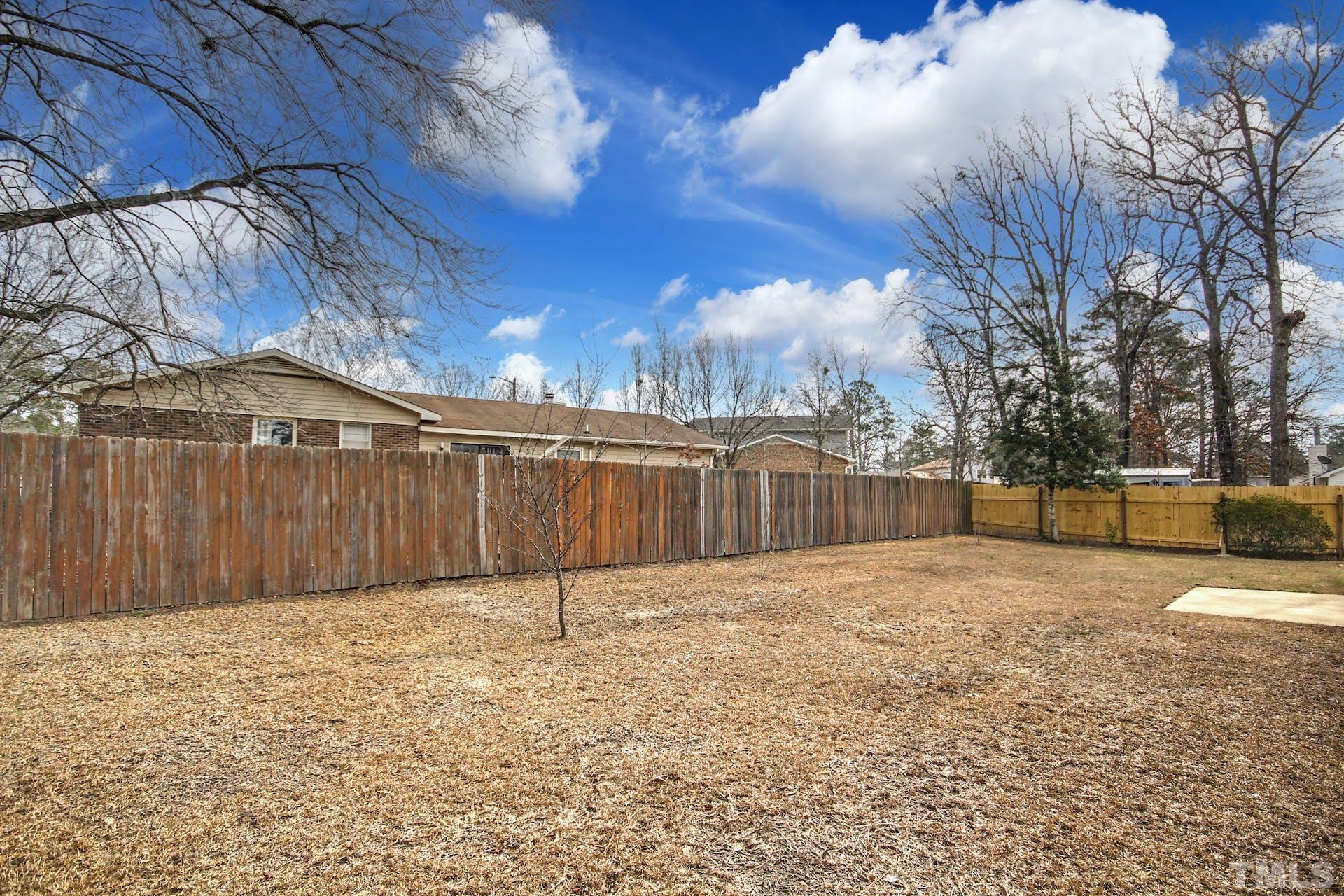 813 Rim Road Fayetteville, NC 28314 - Photo 23 of 25 a view of backyard with wooden fence