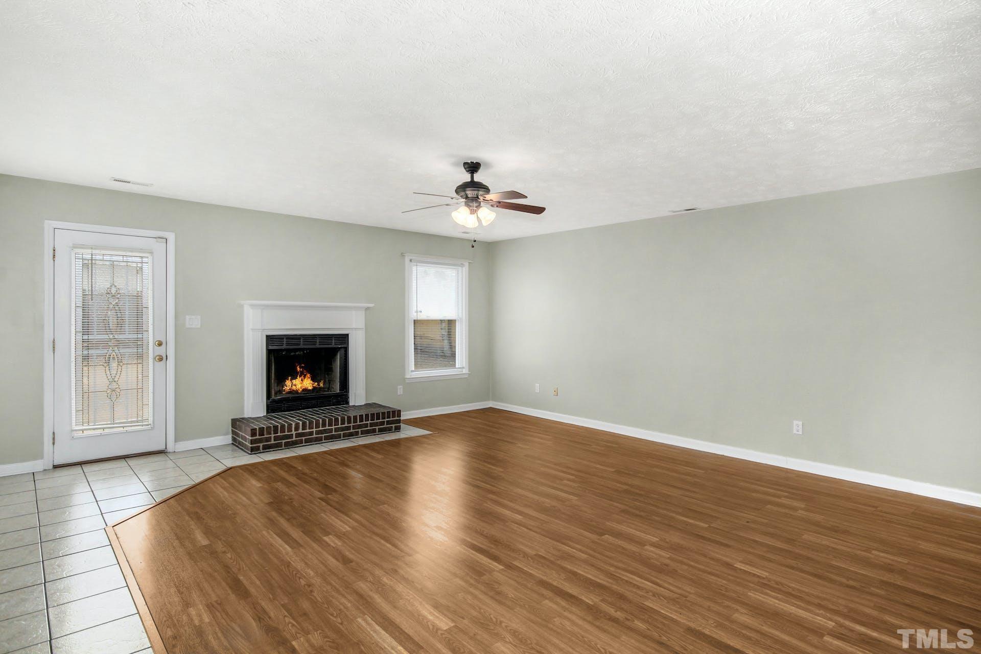 813 Rim Road Fayetteville, NC 28314 - Photo 3 of 25 an empty room with windows and fireplace