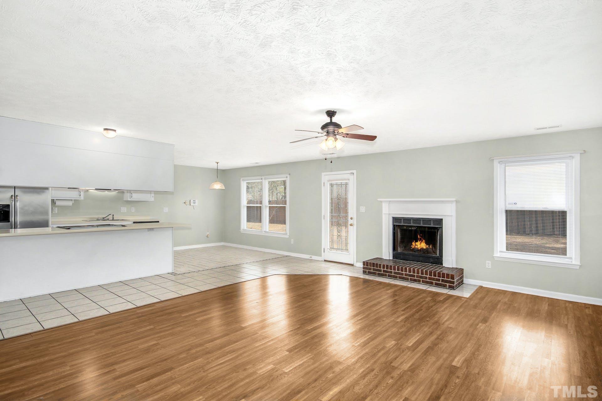 813 Rim Road Fayetteville, NC 28314 - Photo 4 of 25 a view of an empty room with a kitchen and a fireplace