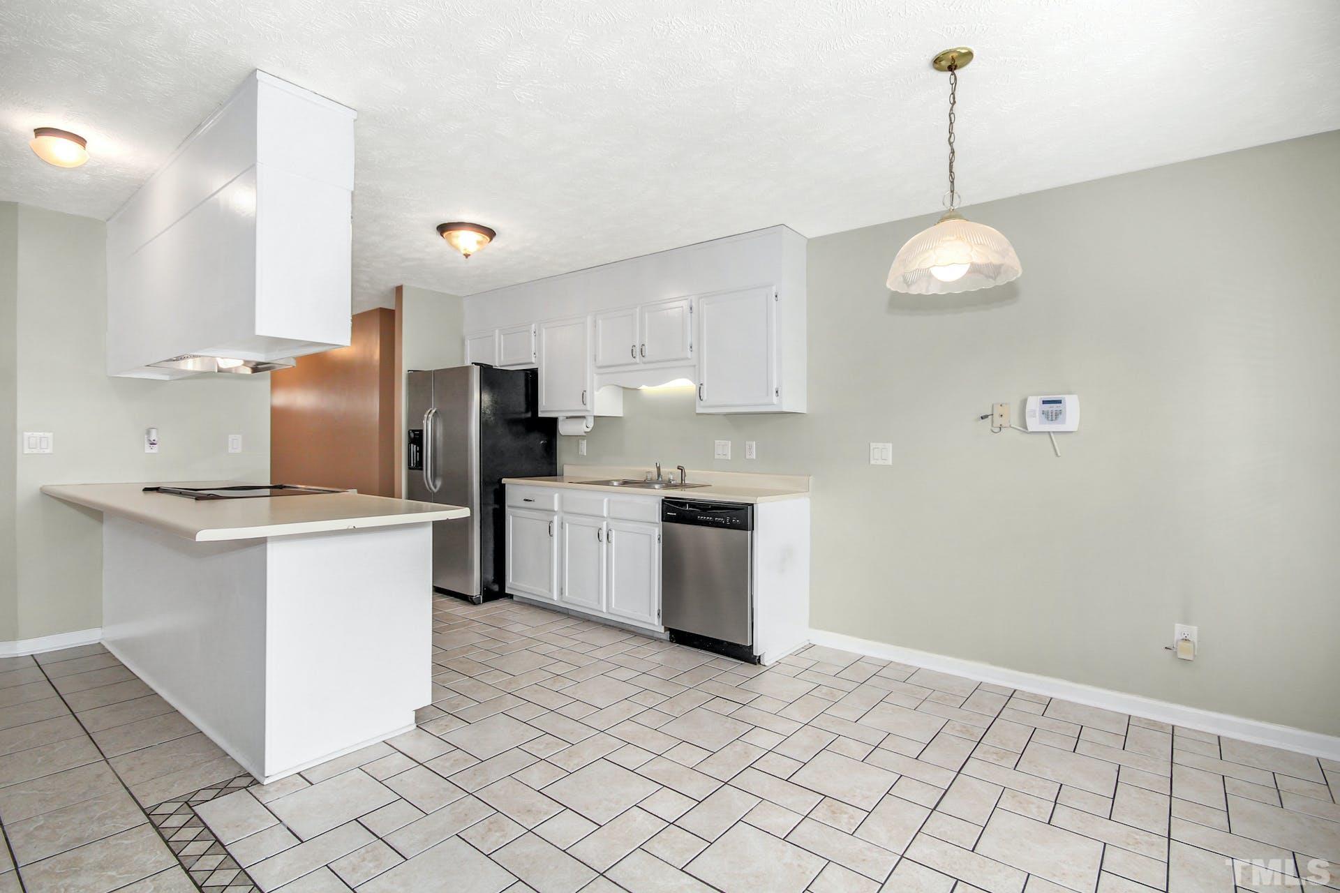 813 Rim Road Fayetteville, NC 28314 - Photo 6 of 25 a kitchen with granite countertop white cabinets and stainless steel appliances