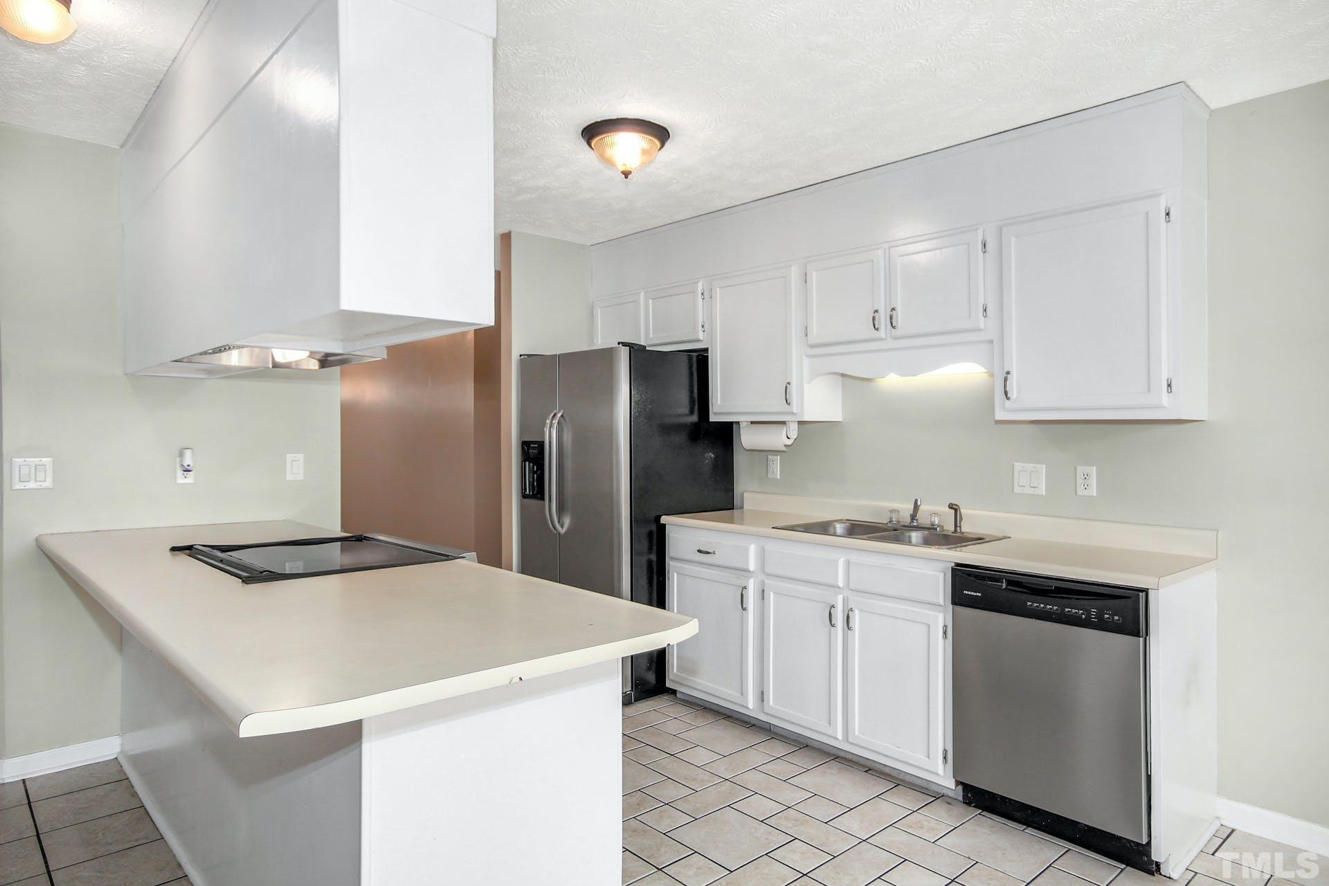 813 Rim Road Fayetteville, NC 28314 - Photo 8 of 25 a kitchen with stainless steel appliances a sink a stove a refrigerator and cabinets