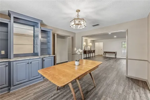 a view of a dining room with furniture and wooden floor