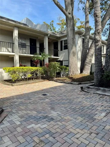 a pathway of a house with a yard