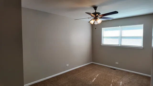 a view of room with window and ceiling fan