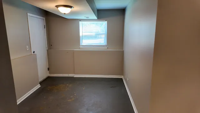 a kitchen with a refrigerator a stove top oven and cabinets