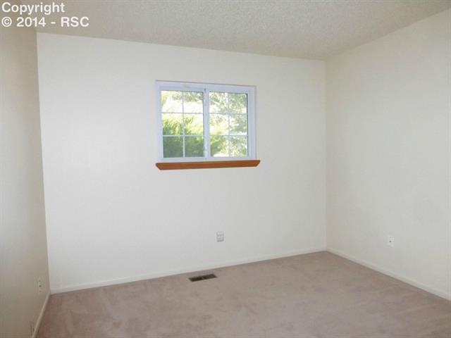 5870 Garmish Road Colorado Springs, CO 80918 - Photo 8 of 10 2nd Bedroom - seller will be hanging new closet doors
