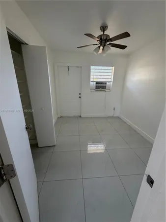 a view of a livingroom with a ceiling fan and window