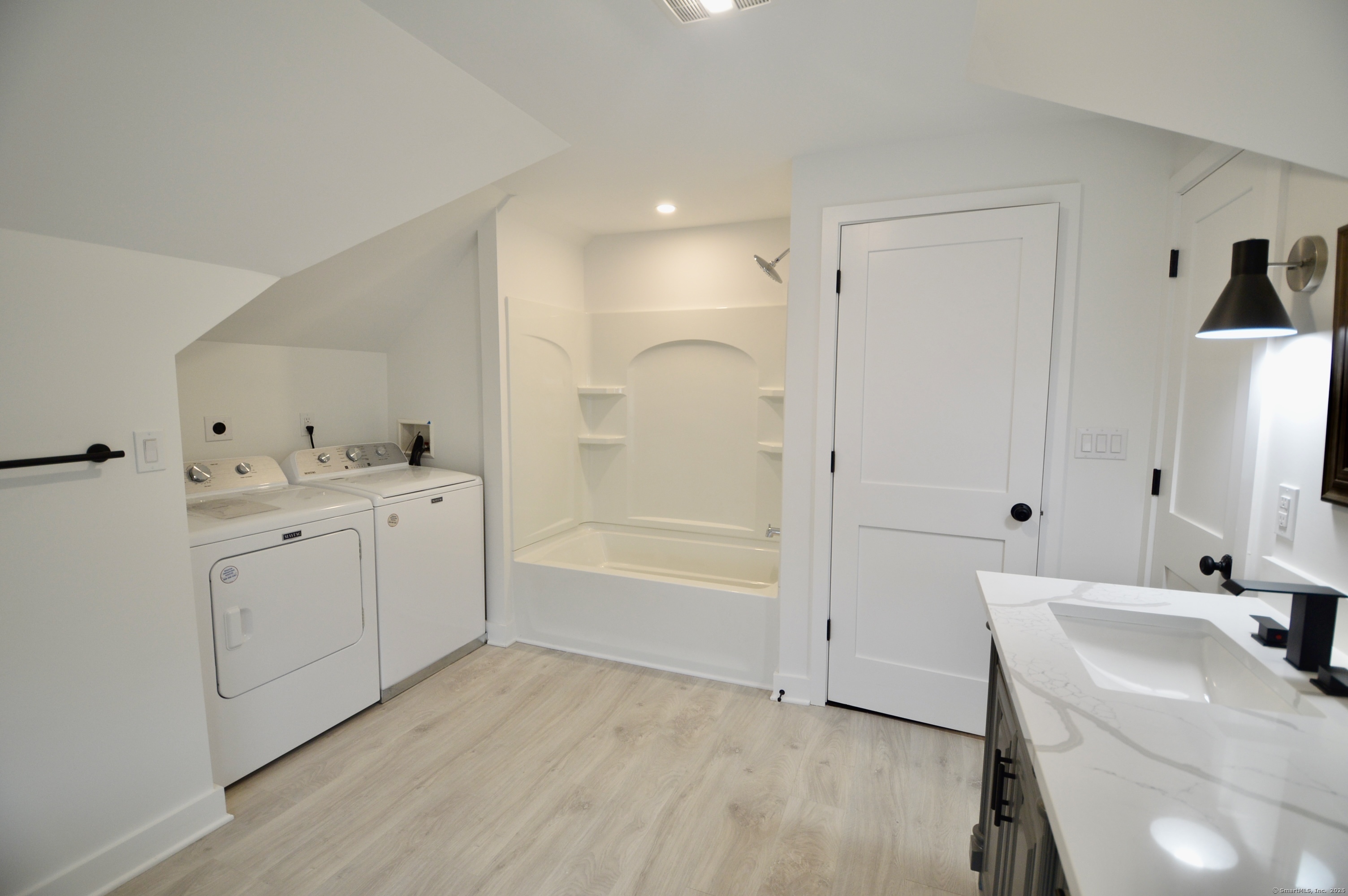 21 Nichols Street Ansonia, CT 06401 - Photo 17 of 21 a bathroom with a granite countertop sink mirror and a bathtub