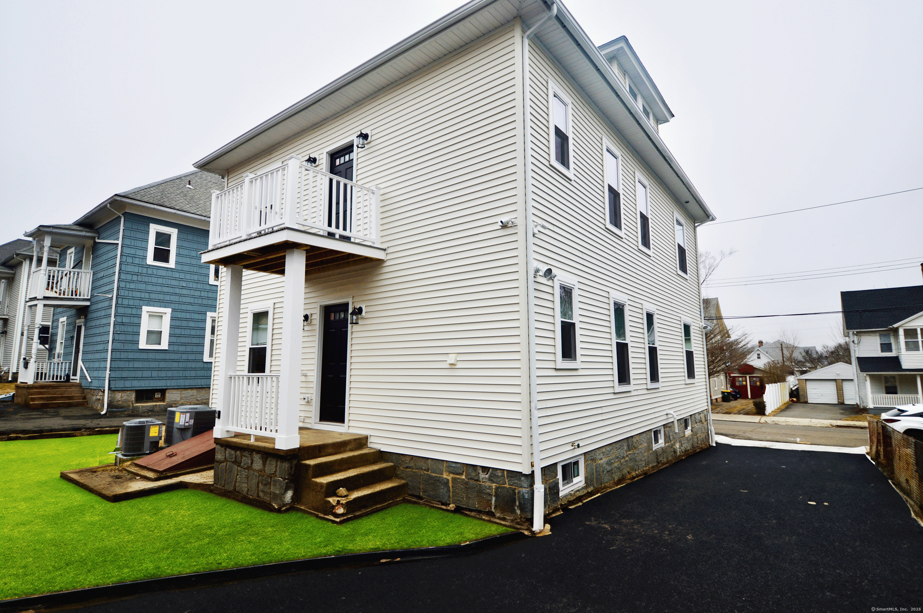 21 Nichols Street Ansonia, CT 06401 - Photo 20 of 21 a front view of a house with a yard table and chairs