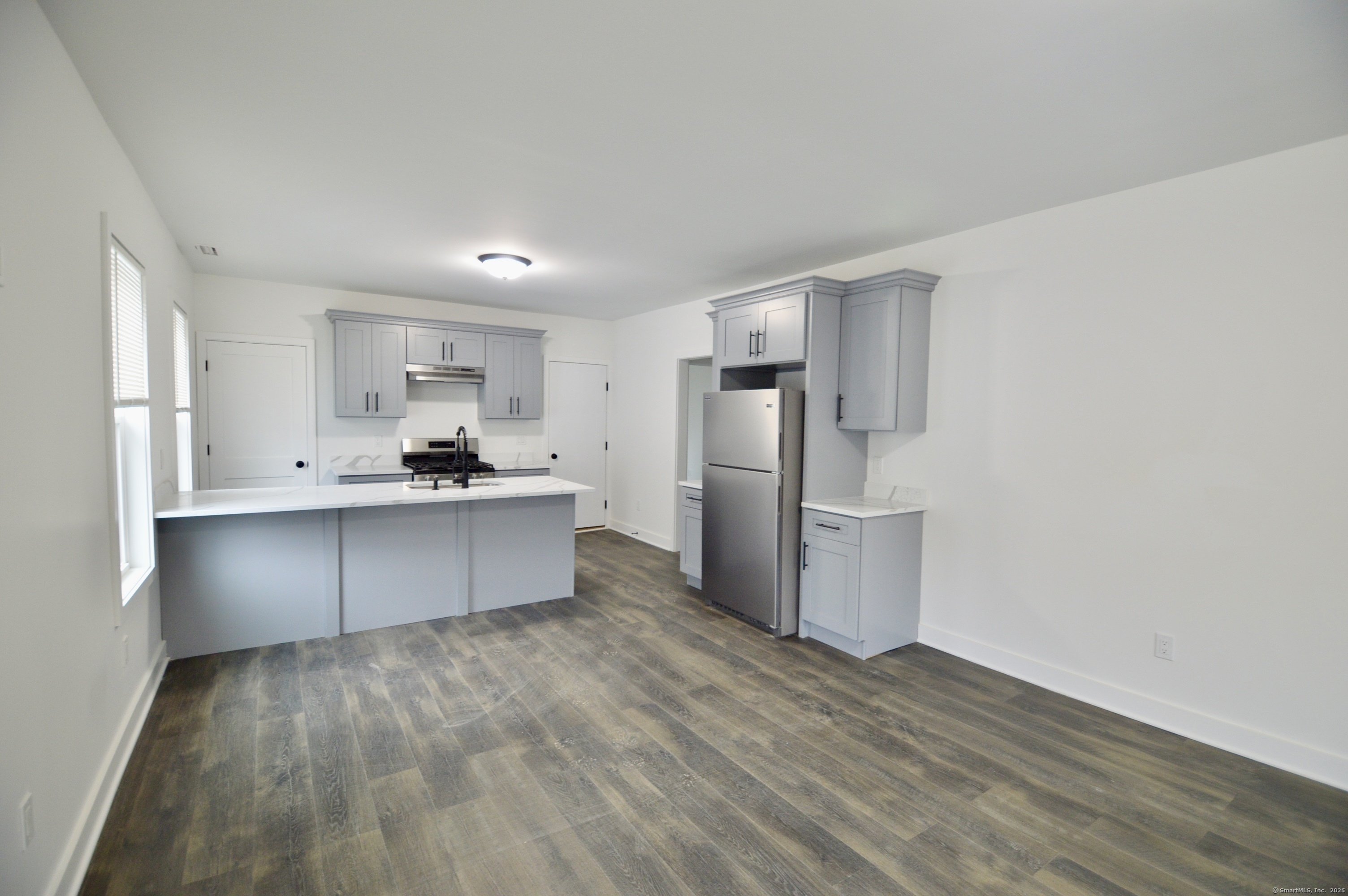 21 Nichols Street Ansonia, CT 06401 - Photo 4 of 21 a kitchen with stainless steel appliances a refrigerator and a stove top oven